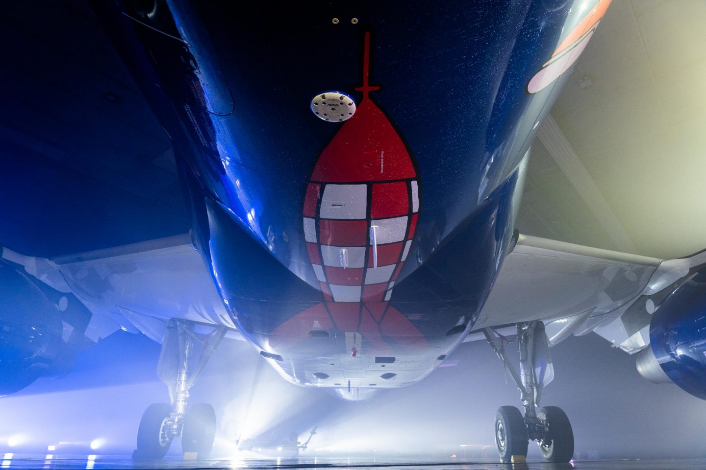 Airplane belly painted with the red and white Tintin space rocket.