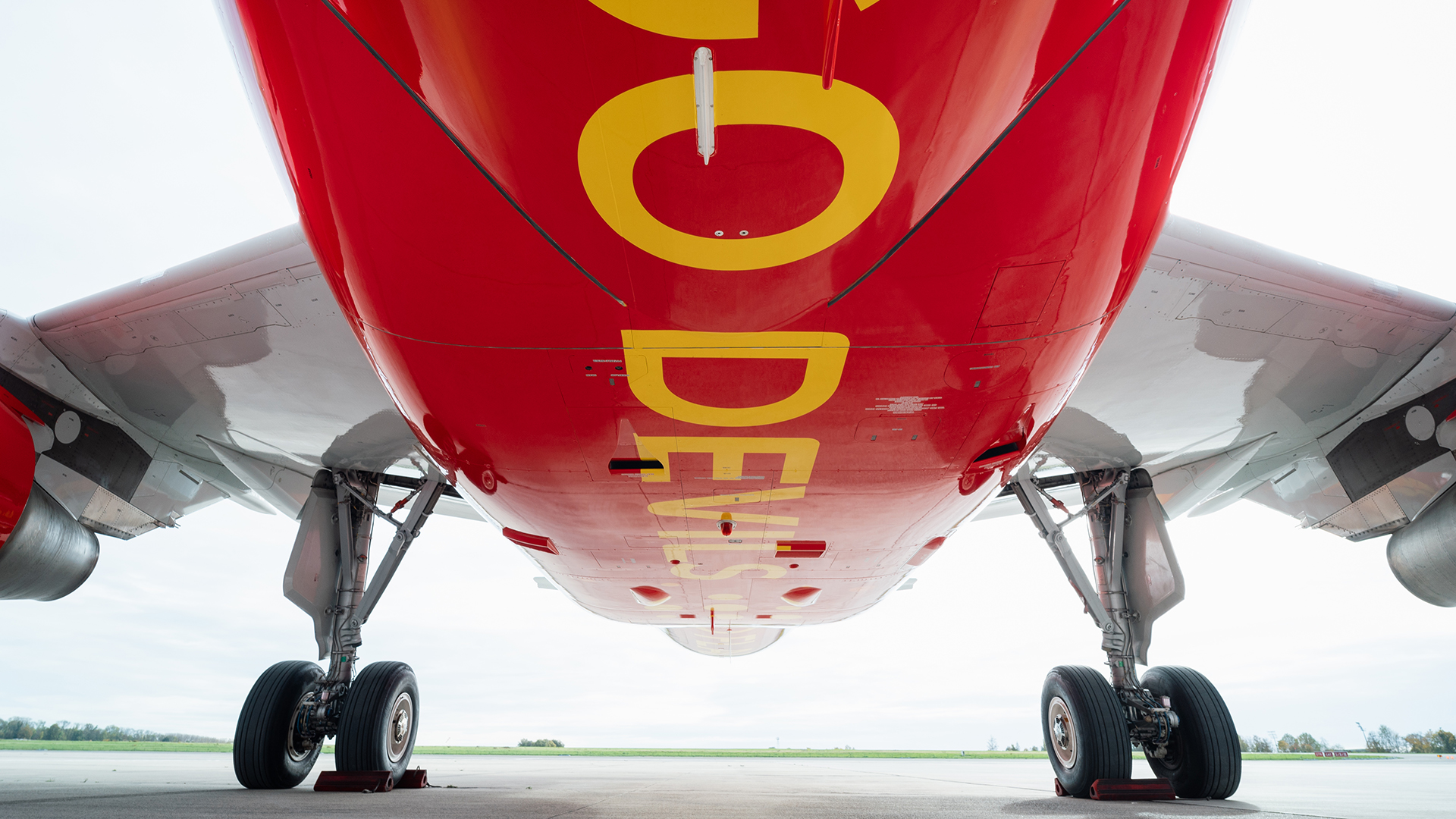 Underside of red airplane fuselage with large yellow GO DEVILS text