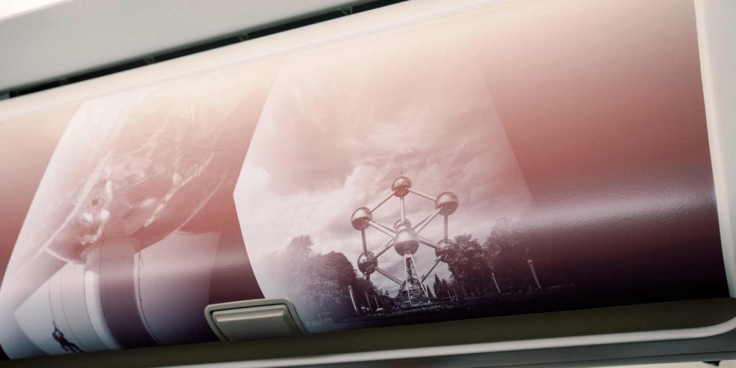 Airplane window shade featuring an image of the Atomium.