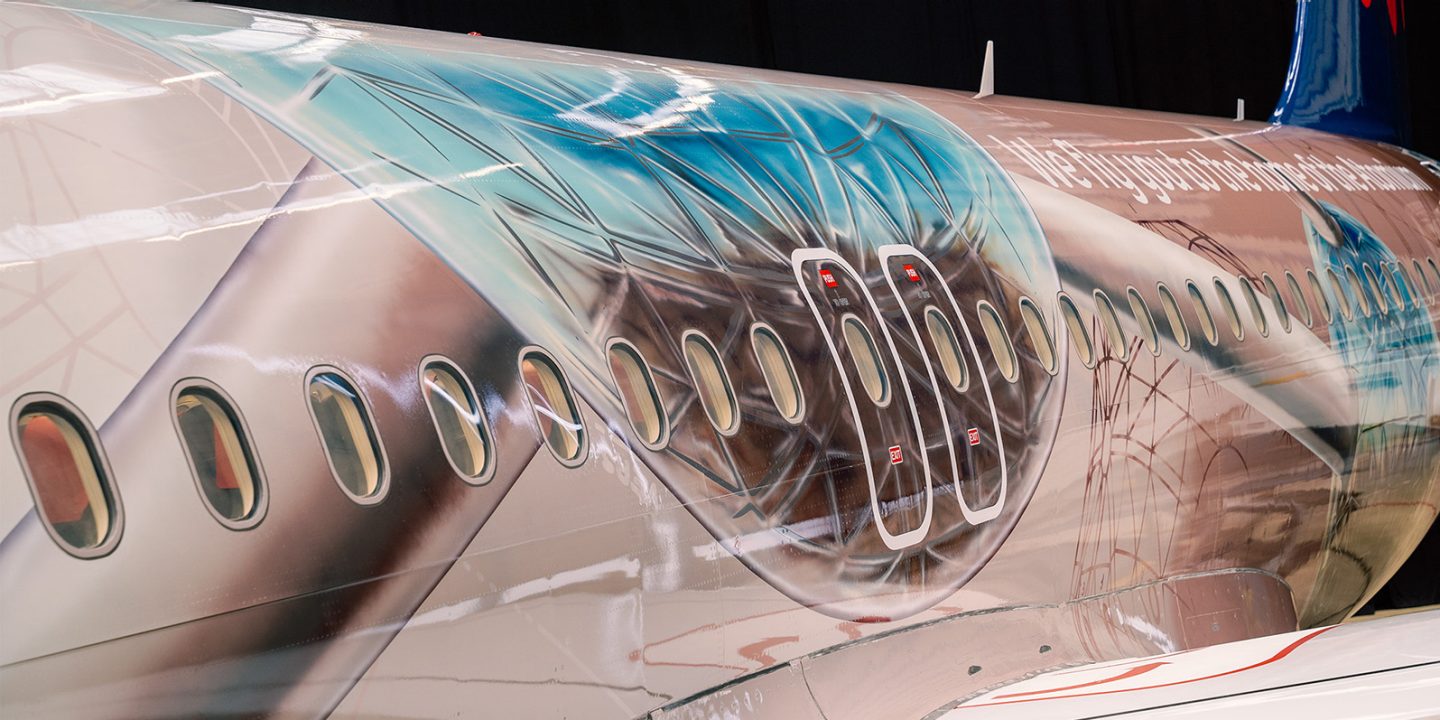 Airplane fuselage featuring an Atomium sphere design.