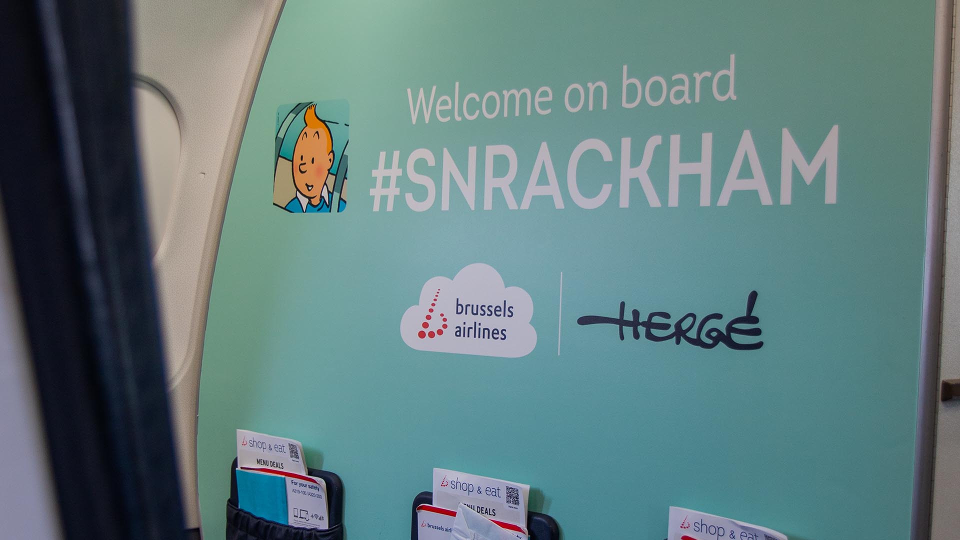 Cabin partition reading Welcome on board SNRACKHAM with a Tintin illustration.