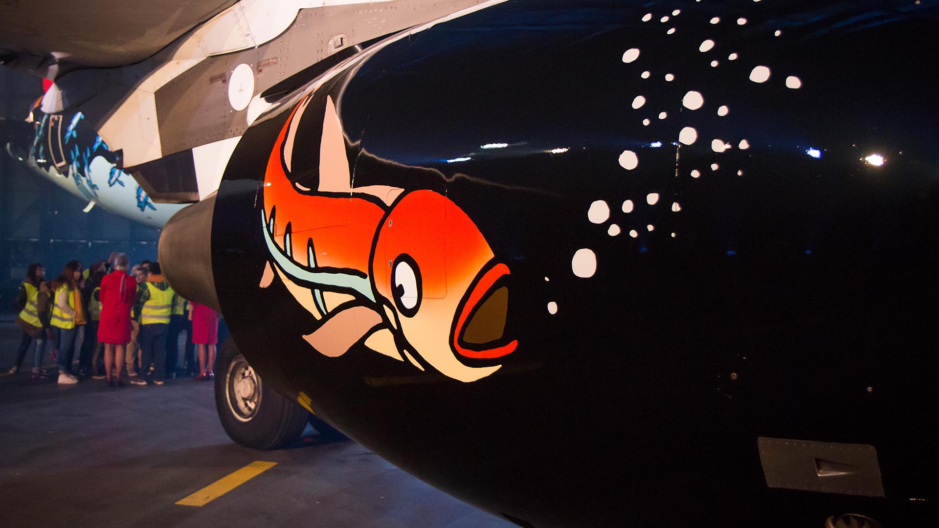 Aircraft engine painted with an orange fish and bubbles.