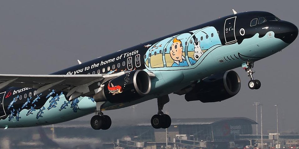 Brussels Airlines Airbus A320 taking off, painted in a black Tintin shark submarine livery featuring Tintin and Snowy.